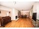 Spacious living room featuring hardwood flooring, a fireplace and an adjacent dining area at 1201 Robinhood Cir, Charlotte, NC 28227