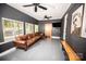 Cozy sunroom with a large leather sofa, a barn door, and a stylish accent wall at 1201 Robinhood Cir, Charlotte, NC 28227