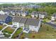 Aerial view of townhomes with cozy backyards, patios, and white fences for privacy, surrounded by well-kept lawns at 1245 Pebble Grove Dr, Clover, SC 29710
