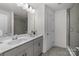 Modern bathroom featuring double sinks, a walk-in shower with glass door, and neutral tile flooring at 1245 Pebble Grove Dr, Clover, SC 29710