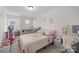 A playful bedroom with a pink bed, whimsical decor, and lots of natural light at 1245 Pebble Grove Dr, Clover, SC 29710
