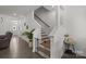 Bright entryway featuring hardwood floors, a staircase, and a plant in a decorative white pot at 1245 Pebble Grove Dr, Clover, SC 29710