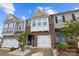 Charming townhome featuring brick facade, white garage door, and a well-manicured front yard at 1245 Pebble Grove Dr, Clover, SC 29710