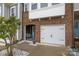 Brick front townhome featuring a garage and arched entryway sitting area at 1245 Pebble Grove Dr, Clover, SC 29710
