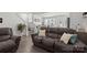 Comfortable living room featuring a plush reclining sofa and open floor plan with hardwood flooring at 1245 Pebble Grove Dr, Clover, SC 29710