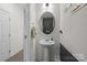 Modern powder room with a pedestal sink, decorative mirror, and stylish fixtures at 1245 Pebble Grove Dr, Clover, SC 29710