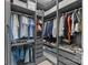Organized walk-in closet with custom shelving, hanging rods, and ample storage space for clothing at 1245 Pebble Grove Dr, Clover, SC 29710