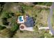 Aerial view of estate with landscaped grounds, pool, and circular driveway at 12932 Westmoreland Farm Rd, Davidson, NC 28036