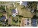 Aerial view of estate with landscaped grounds, pool, circular driveway, and neighborhood at 12932 Westmoreland Farm Rd, Davidson, NC 28036