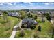 Stunning aerial view of a brick home with a curved driveway and beautifully landscaped front yard at 12932 Westmoreland Farm Rd, Davidson, NC 28036