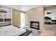 Luxurious bathroom featuring a soaking tub, fireplace, and access to the main bedroom at 12932 Westmoreland Farm Rd, Davidson, NC 28036