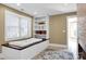 Bathroom with an enclosed tub, built-in shelving, and a neutral color scheme at 12932 Westmoreland Farm Rd, Davidson, NC 28036