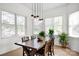 Inviting dining area featuring a wooden table, multiple windows, and pendant lighting at 12932 Westmoreland Farm Rd, Davidson, NC 28036