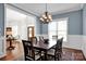 Elegant dining room has chair rail molding, a chandelier, and is open to the foyer and entry at 12932 Westmoreland Farm Rd, Davidson, NC 28036