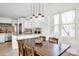 Dining area featuring a wooden table, pendant lighting, and open floor plan at 12932 Westmoreland Farm Rd, Davidson, NC 28036