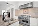 This kitchen features a stainless steel range with granite countertops and a tile backsplash at 12932 Westmoreland Farm Rd, Davidson, NC 28036