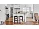 Open kitchen with bar seating, stainless appliances, and white cabinets at 12932 Westmoreland Farm Rd, Davidson, NC 28036