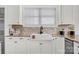 Charming kitchen features granite countertops, stainless steel appliances, and white cabinetry at 12932 Westmoreland Farm Rd, Davidson, NC 28036