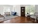 Cozy living room with a decorative antique corner cabinet, hardwood floors, and lots of natural light at 12932 Westmoreland Farm Rd, Davidson, NC 28036