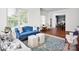 This living room is bathed in natural light and features hardwood floors, seating, and an area rug at 12932 Westmoreland Farm Rd, Davidson, NC 28036