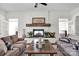 Living room boasts a stone fireplace, neutral decor, and ample seating at 12932 Westmoreland Farm Rd, Davidson, NC 28036