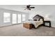 Bright main bedroom with a ceiling fan and French doors leading to a balcony at 12932 Westmoreland Farm Rd, Davidson, NC 28036