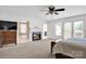 Open main bedroom with fireplace, mounted television, and access to a balcony at 12932 Westmoreland Farm Rd, Davidson, NC 28036