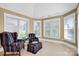 Cozy sitting area with chairs, ottoman, and plenty of natural light at 12932 Westmoreland Farm Rd, Davidson, NC 28036