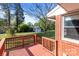Back deck leading to a lush backyard with shade trees at 1315 Arbor Dr, Salisbury, NC 28144