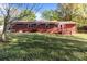 The brick home features an expansive backyard, a wooden deck and verdant lawn at 1315 Arbor Dr, Salisbury, NC 28144