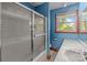 Bathroom featuring a tub with glass door, neutral tiling, single sink vanity at 1315 Arbor Dr, Salisbury, NC 28144
