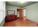 Bedroom featuring hardwood floors, neutral walls, dresser and a closet at 1315 Arbor Dr, Salisbury, NC 28144