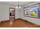 Bright dining room with hardwood floors, chandelier, and natural light from the window at 1315 Arbor Dr, Salisbury, NC 28144