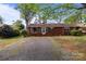 Charming brick home with large trees and gravel driveway at 1315 Arbor Dr, Salisbury, NC 28144