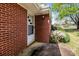 View of the home's front entrance with brick and mature landscaping at 1315 Arbor Dr, Salisbury, NC 28144
