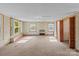 Large room with three windows, carpeted floors and dated wall paper at 1315 Arbor Dr, Salisbury, NC 28144