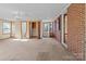 Spacious living room featuring carpet, ample natural light, and a brick wall accent at 1315 Arbor Dr, Salisbury, NC 28144