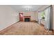 Spacious living room with a fireplace, large window, and neutral walls at 1315 Arbor Dr, Salisbury, NC 28144