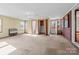 Bright and airy living room with carpet, brick accents, and access to the outdoors at 1315 Arbor Dr, Salisbury, NC 28144