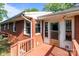 A brick home featuring a wooden deck leading to the back entrance with white trim windows at 1315 Arbor Dr, Salisbury, NC 28144