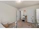 Spare bedroom featuring neutral carpet and walls, with an adjacent vanity and lighting at 1354 Galloway Rd, Charlotte, NC 28262