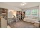 Bright bedroom offers a vanity, shelving, and a comfortable seating area by large windows at 1354 Galloway Rd, Charlotte, NC 28262