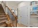 Hallway with view of kitchen, hardwood floors, stairwell, and decoratively adorned white walls at 1354 Galloway Rd, Charlotte, NC 28262