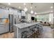 Open concept kitchen features a large island, stainless steel appliances, and decorative pendant lighting at 1354 Galloway Rd, Charlotte, NC 28262
