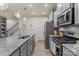 Kitchen features granite countertops, stainless steel appliances, gray cabinets, and hardwood floors at 1354 Galloway Rd, Charlotte, NC 28262