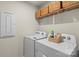 Functional laundry area with washer, dryer, and upper storage at 1354 Galloway Rd, Charlotte, NC 28262