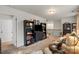 Cozy living room featuring built-in bookshelves, comfortable seating, and access to the upper level at 1354 Galloway Rd, Charlotte, NC 28262