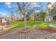 Expansive backyard with lush green grass, mature trees, and a storage shed at 13924 Island Dr, Huntersville, NC 28078