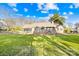 Expansive backyard featuring a brick patio with a stone fireplace and a screened-in porch, perfect for outdoor living at 13924 Island Dr, Huntersville, NC 28078