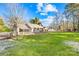 Large backyard features a well-manicured lawn, mature trees, and outdoor living spaces at 13924 Island Dr, Huntersville, NC 28078